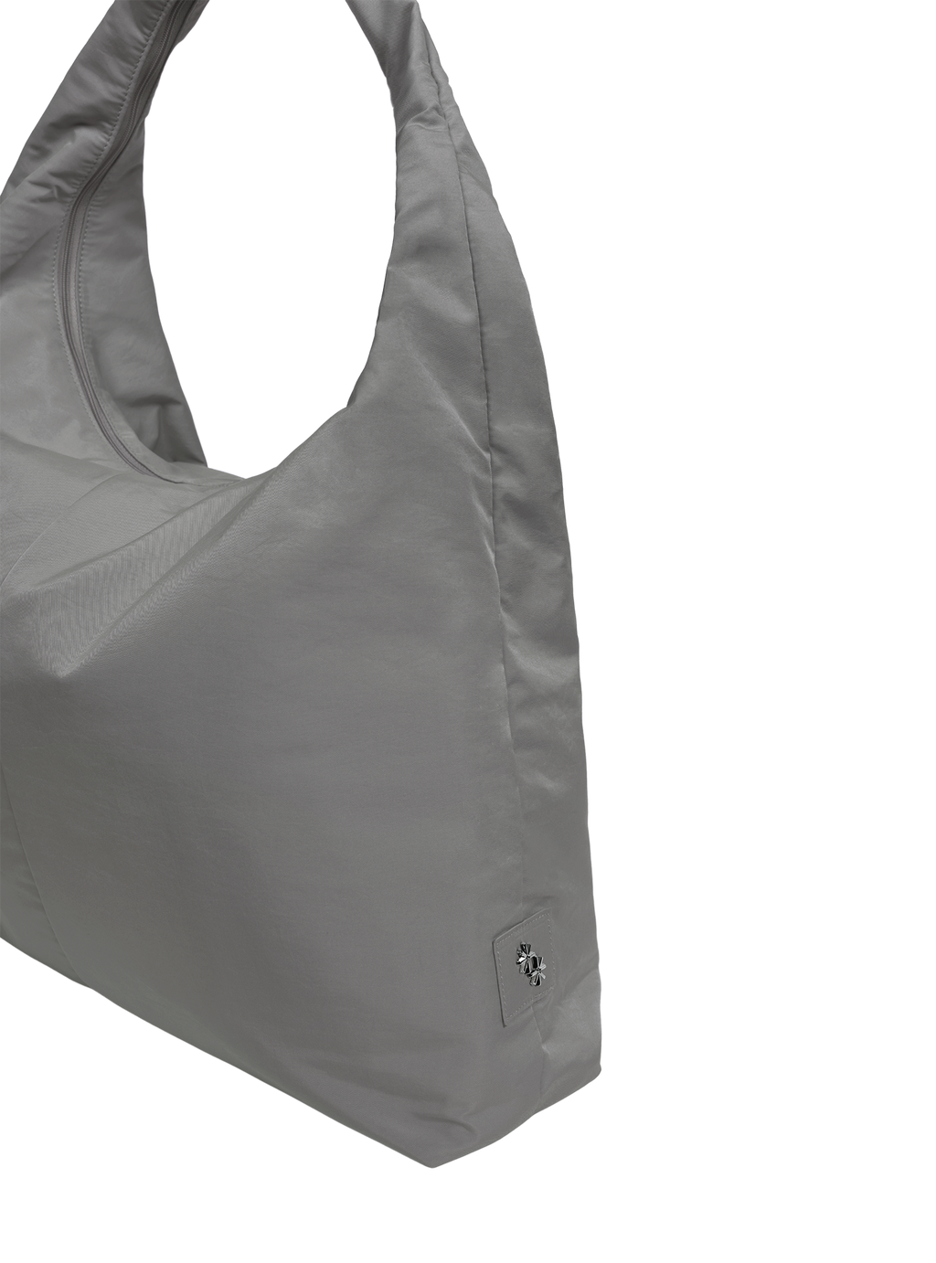 Close-up of the Arc hobo-style bag in grey nylon, showing metal logo emblem