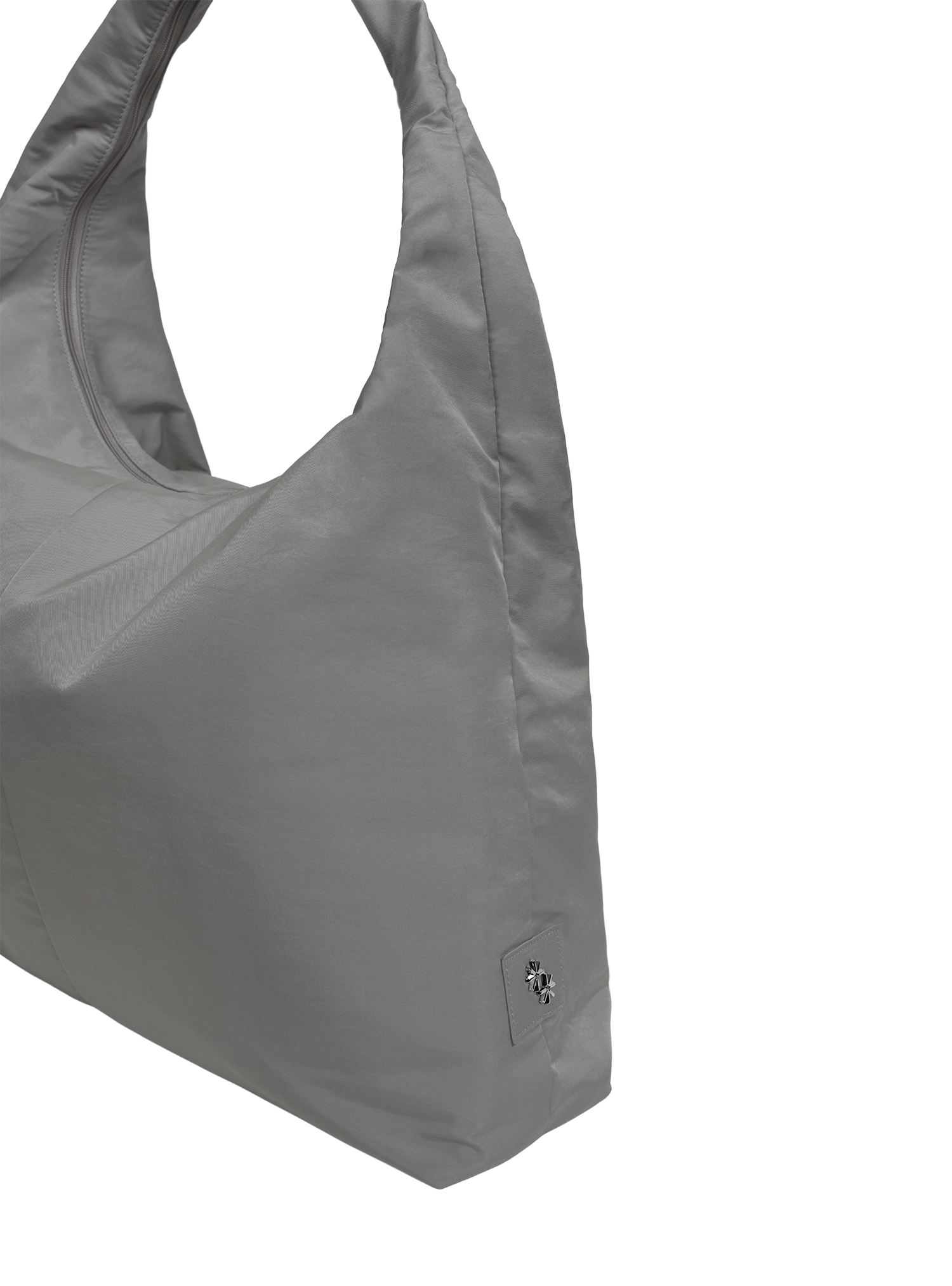 Close-up of the Arc hobo-style bag in grey nylon, showing metal logo emblem