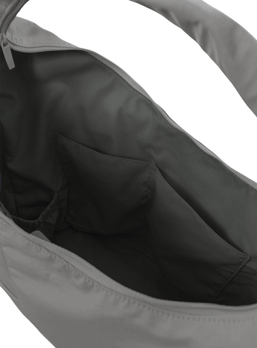Interior of the Arc hobo-style bag in grey nylon, with multiple pockets and a bottle holder