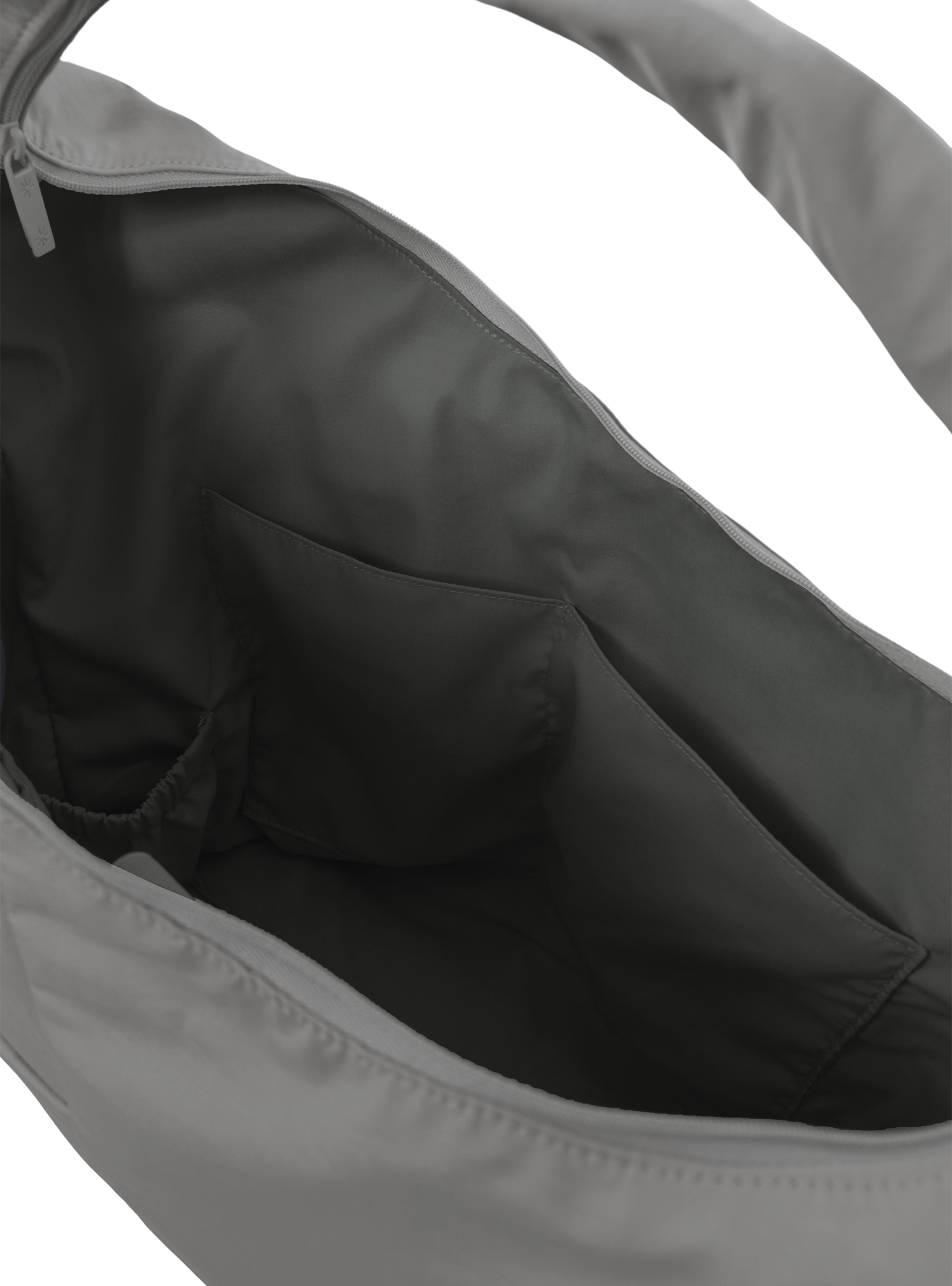 Interior of the Arc hobo-style bag in grey nylon, with multiple pockets and a bottle holder