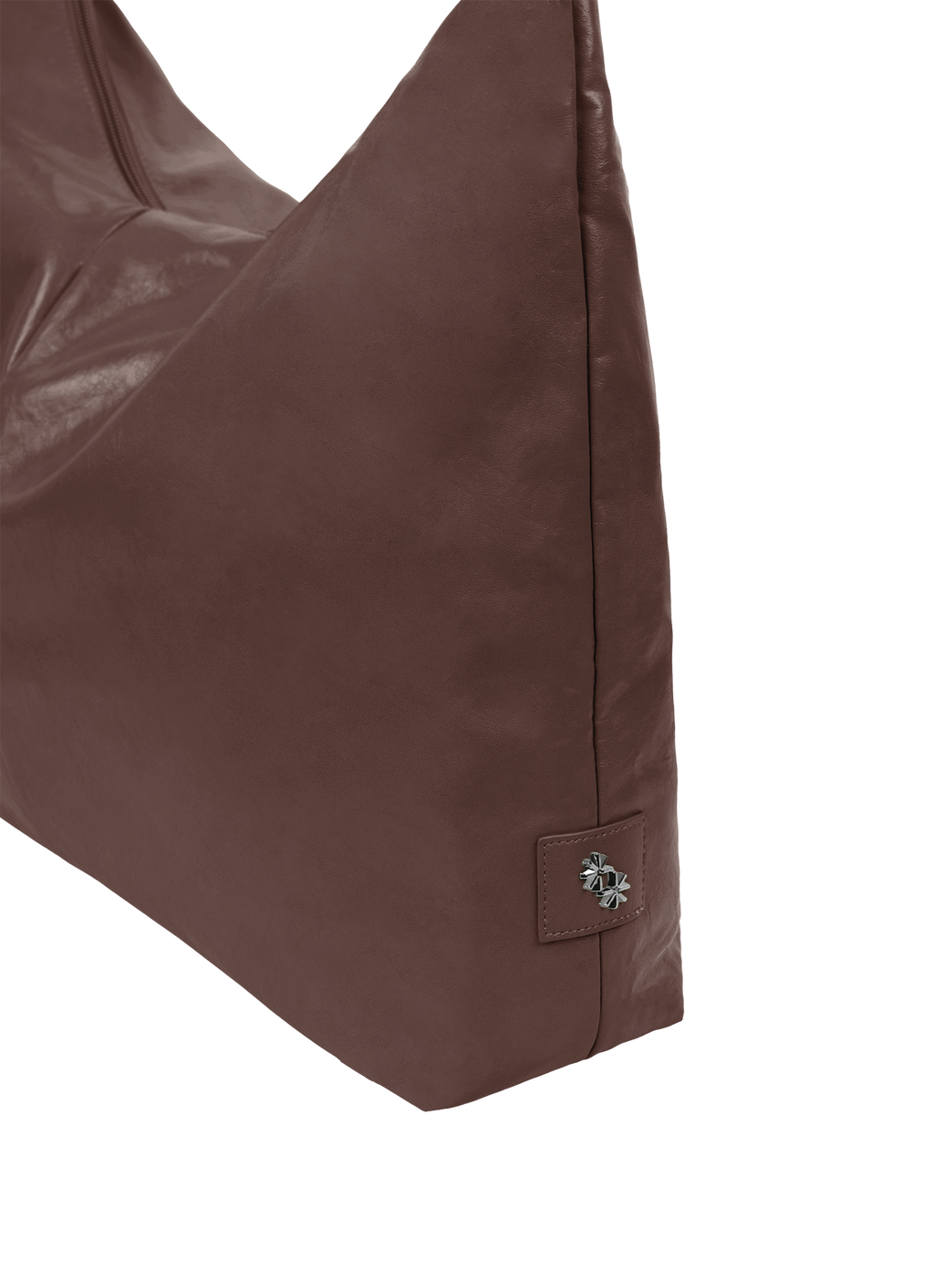 Close-up of the Arc hobo-style bag in dark reddish brown matte vegan leather, showing metal logo emblem