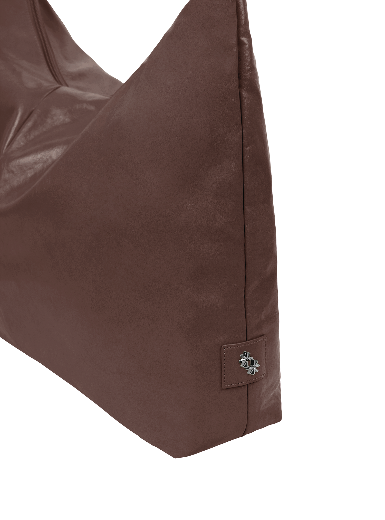 Close-up of the Arc hobo-style bag in dark reddish brown matte vegan leather, showing metal logo emblem