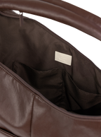 Interior of the Arc hobo-style bag in dark reddish brown matte vegan leather, with multiple pockets