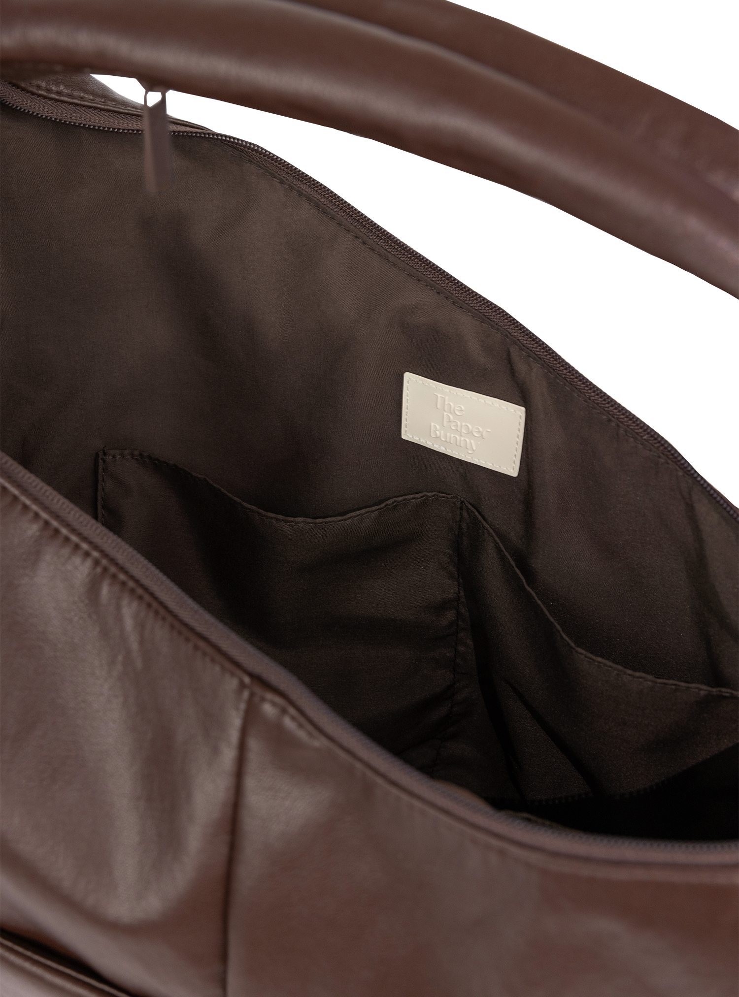Interior of the Arc hobo-style bag in dark reddish brown matte vegan leather, with multiple pockets