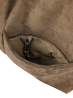 Exterior pocket of the Arc hobo-style bag in grey-beige suede, with concealed snap loop